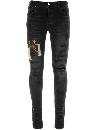 Amiri Leather Staggered Logo Ripped Jeans in Black