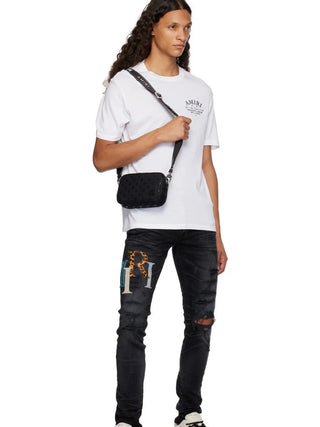 Amiri Leather Staggered Logo Ripped Jeans in Black